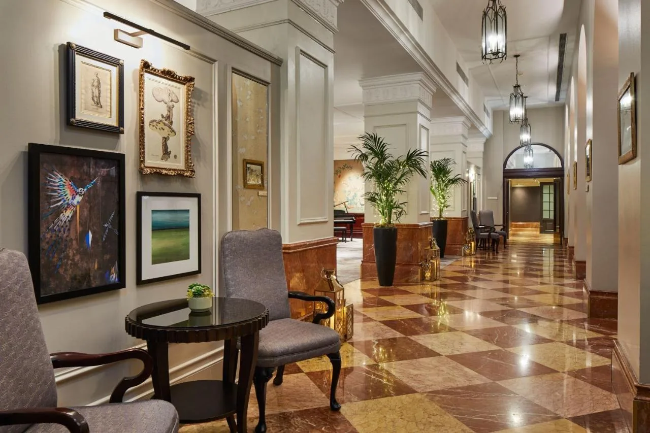 a hallway with chairs and a table in a building at Bristol Marriott Royal Hotel in Bristol
