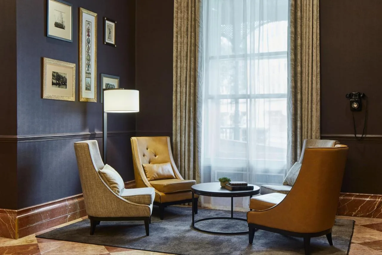 a living room with chairs and a table and a window at Bristol Marriott Royal Hotel in Bristol